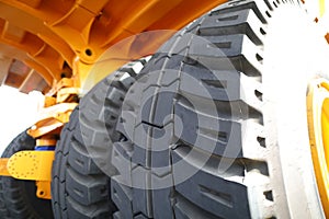 Huge rear wheels of dump truck at unusual angle