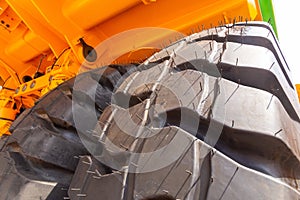 Huge rear wheels of dump truck at unusual angle closeup