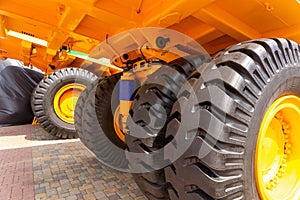 Huge rear wheels of dump truck at unusual angle closeup