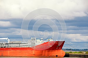 The huge red tanker moored in harbor