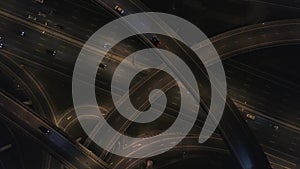 Huge Road Junction view from Above. Night on Freeway Interchange. 4K Aerial.