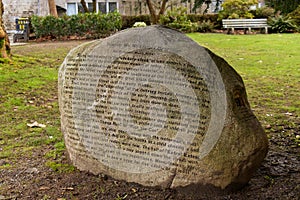 A huge rock with a poem inscribed on it on the back lawn of the Vancouver City Hall by Ina Trudge on March 2000