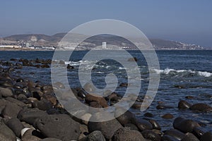 Landscape with huge rocks blue sea foam waves and blue sky beach of Baja California Mexico photo