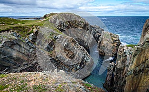 Huge rocks and boulder outcrops along Cape Bonavista coastline in Newfoundland, Canada.