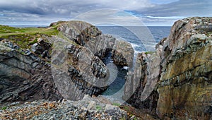 Huge rocks and boulder outcrops along Cape Bonavista coastline in Newfoundland, Canada. photo