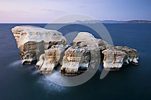 Huge rocks in the sea from Sarakiniko beach in Milos island Greece at sunset time