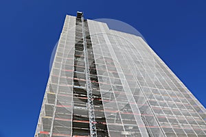 huge scaffolding of the skyscraper during maintenance to install the thermal insulation for energy saving without people photo