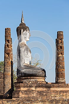 Huge sitting Buddha sculpture in Wat Mahathat in the Historical Park of Sukhothai, Thailand, Asia