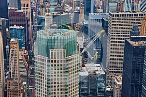 Huge skyscraper under construction high up in New York City Manhattan with cranes