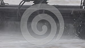 A huge snow blower cleans the runway. A close-up of a snow blower brush