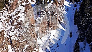 A huge snow cliff. Flows down the waterfall. Huge icicles and ice.