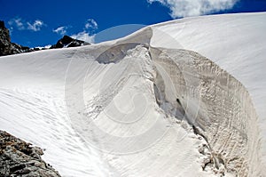 Huge snow-covered crevasse photo