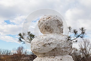 Huge spring snowman in melted meadow. Background with copy space for lettering or text