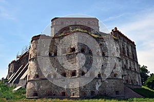 A huge stone fortress in several tiers with loopholes and embrasures
