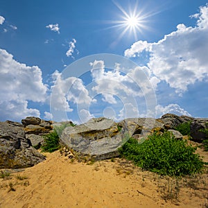 huge stones on sandy hill under a sparkle sun