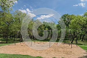 Huge swing set in nature park with tree lush at Ennis, Texas, US