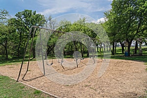 Huge swing set in nature park with tree lush at Ennis, Texas, US