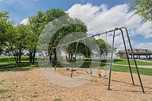 Huge swing set in nature park with tree lush at Ennis, Texas, US