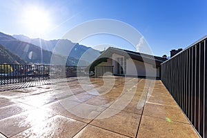 Huge terrace on a sunny day overlooking the Swiss Alps