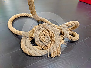 Huge thick rope used in gym for training and exercise shot at indoor well equipped gym
