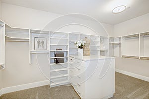 Huge walk-in closet with shelves, drawers and clothes rails