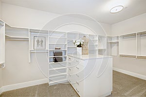 Huge walk-in closet with shelves, drawers and clothes rails photo
