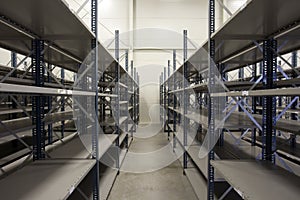 Huge warehouse with empty racks inside for storage modern design, metal shelves for distribution