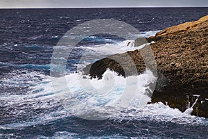 Huge waves crash on cloudy day. Kemmuna island