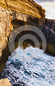 Huge waves crash on cloudy day. Kemmuna island