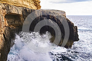 Huge waves crash on cloudy day. Kemmuna island