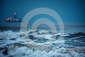 Huge waves in the deep sea water after sunset. Ca