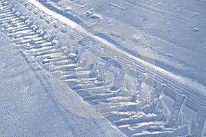 Huge wheel trail with deep tread in the snow, close-up, selective focus