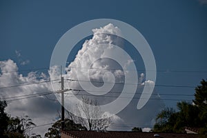 Huge White Billowing Cumulonimbus cloud in blue sky. Australia. Atmospheric sky art image