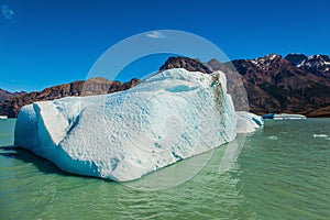 The huge white-blue iceberg drifts