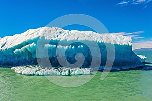 The huge white-blue iceberg floats