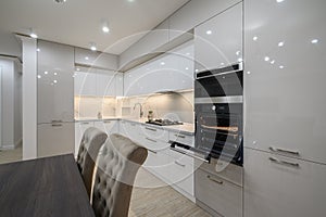 Huge white luxury kitchen in a studio apartment interior