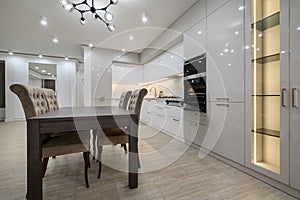 Huge white luxury kitchen in a studio apartment interior