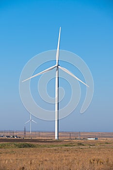 Huge wind generators against blue sky, close up