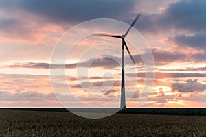 Huge windmill in motion at sunset