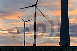 Huge windmill in motion at sunset