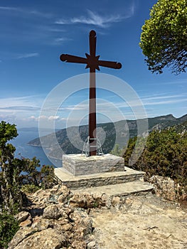 Huge wooden Orthodox eight-pointed cross against the sky after the dawn on Mount Athos