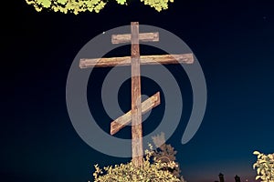 Huge wooden Orthodox eight-pointed cross against the sky after sunset on Mount Athos