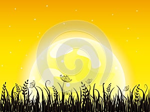 Huge yellow moon with grass meadow
