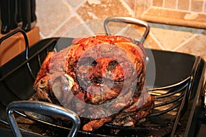 A hugeroasted Pernil which is a roast pork butt has a delicious golden brown, crispy skin. photo