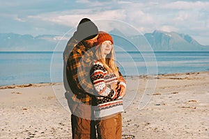 Hugging couple on beach traveling together