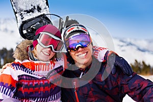 Hugging couple in ski masks together