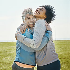 Hugging, fitness and senior women bonding together in an outdoor park after a workout or exercise. Happy, smile and