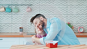 Hugging young father and little daughter in home interior