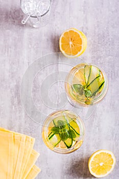Hugo spritz sparkling cocktail with champagne, cucumber, lemon and mint in glasses top and vertical