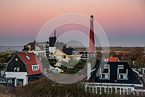 Huisduinen, the Netherlands. january 2022. Setting sun over the village and the lighttower. photo